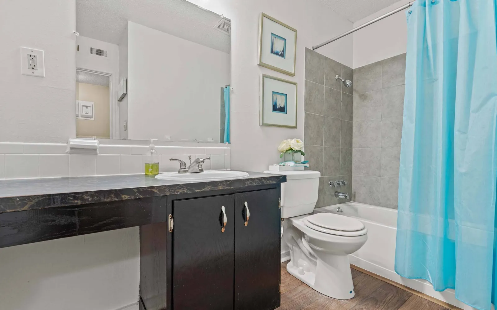 Arbors of Grandview - a bathroom with a sink, toilet, and tub
