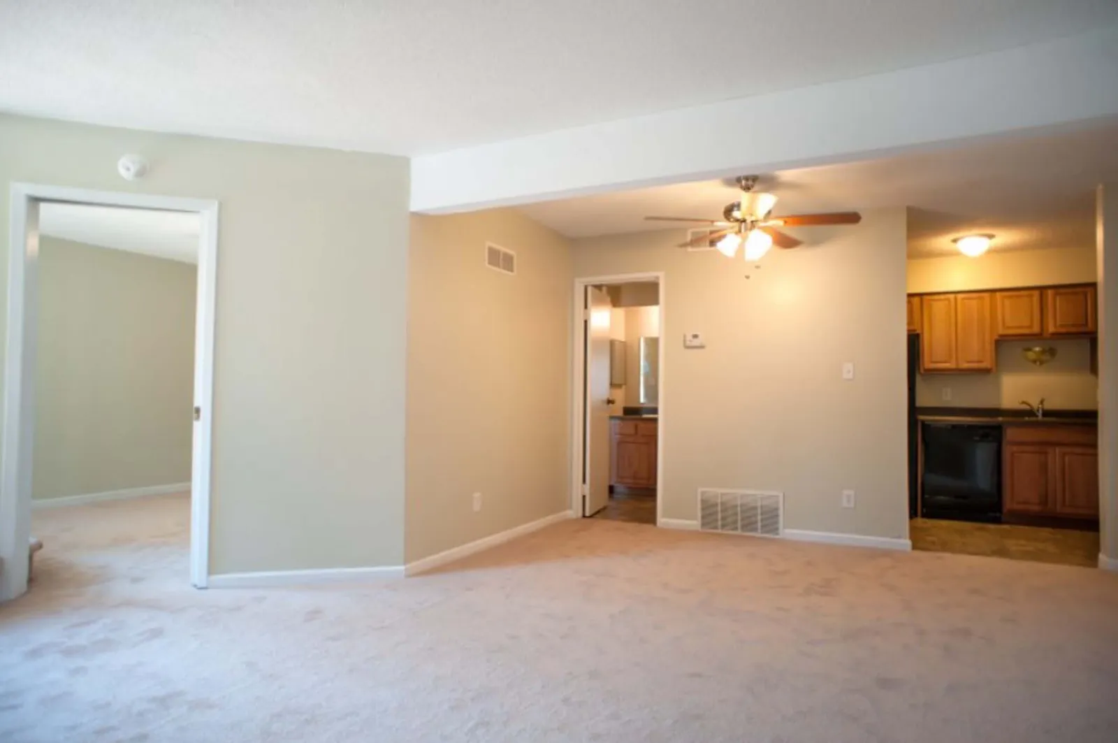 Forest Park Apartments - a living room with a ceiling fan and hallways