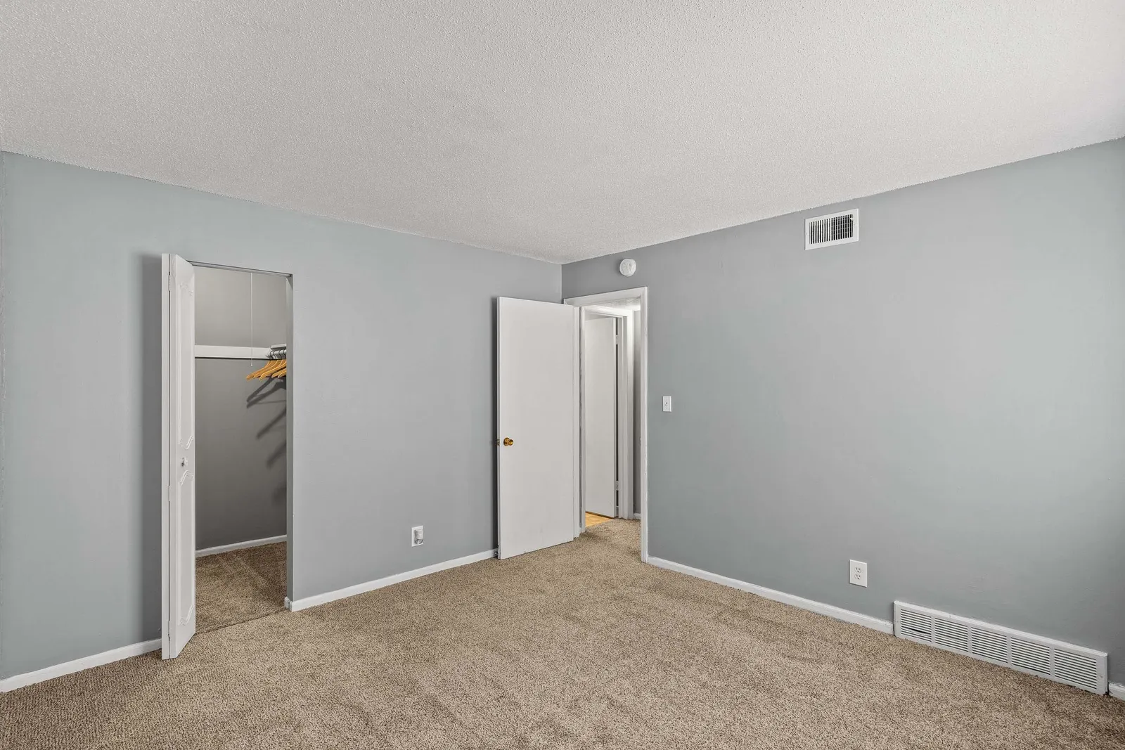 Forest Park Apartments - a bedroom with an open door and walk in closet