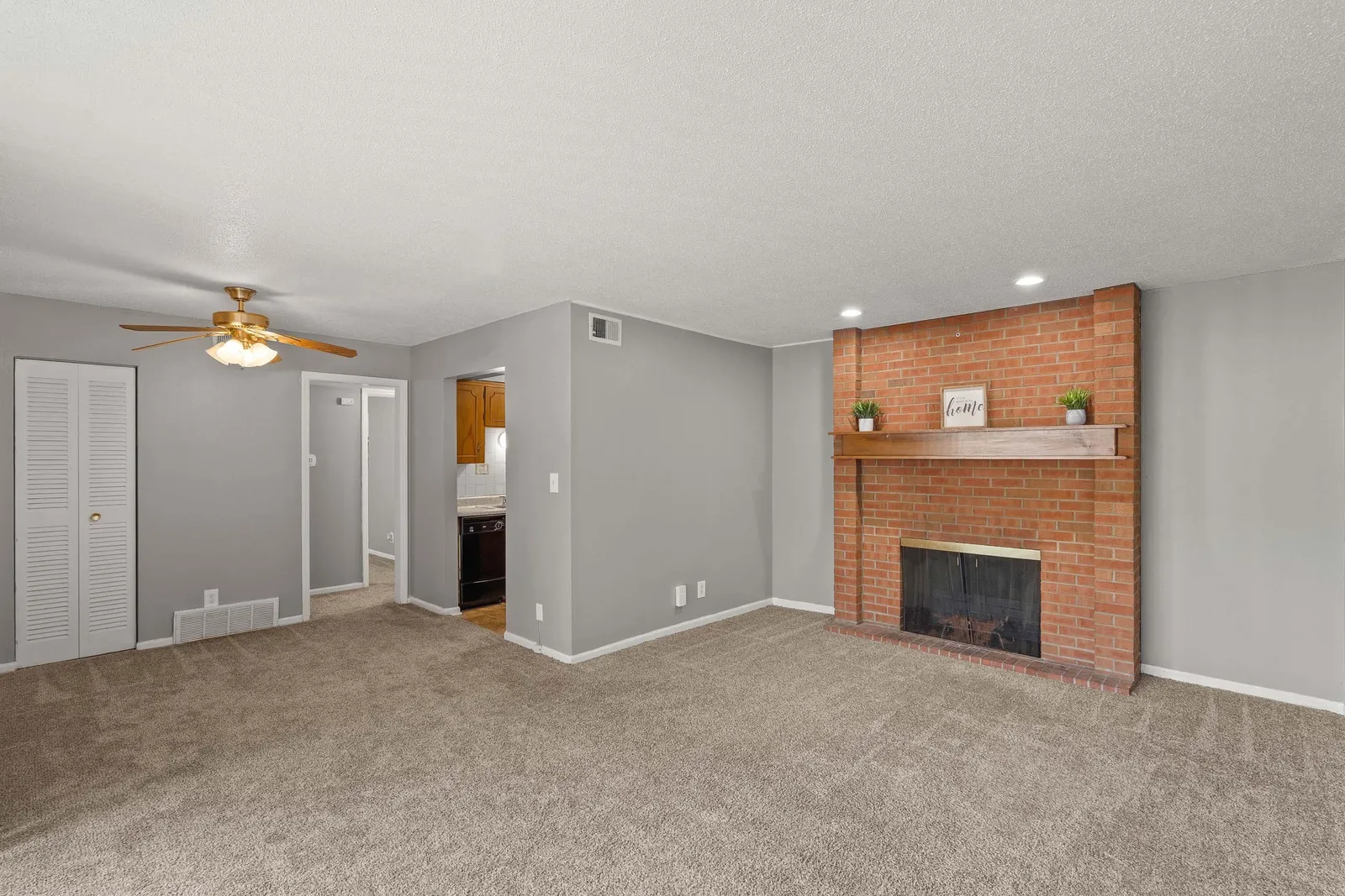 Forest Park Apartments - a living room with a red stone brick fireplace