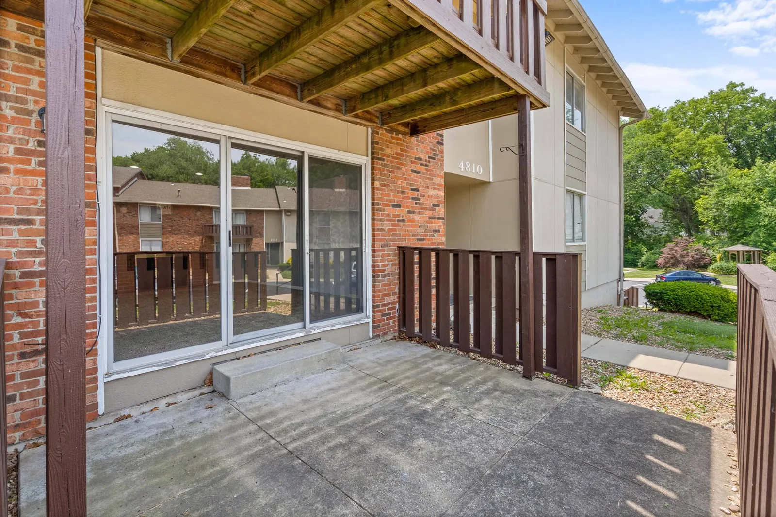 Forest Park Apartments - a patio with sliding door windows