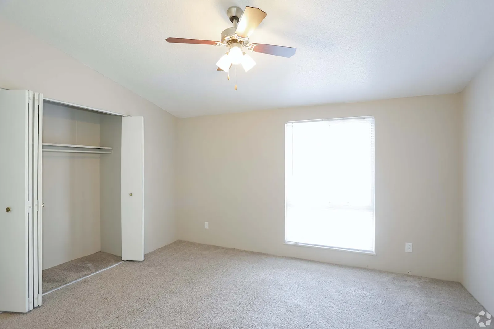 Forest Park Apartments - a bedroom with an open closet, ceiling fan, and window