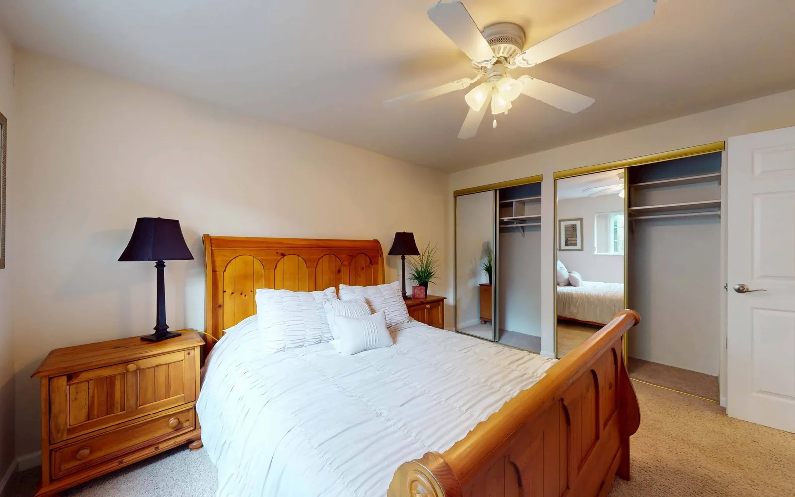 Grant 79 Apartment Homes - a bedroom with a bed, two closets, and ceiling fan