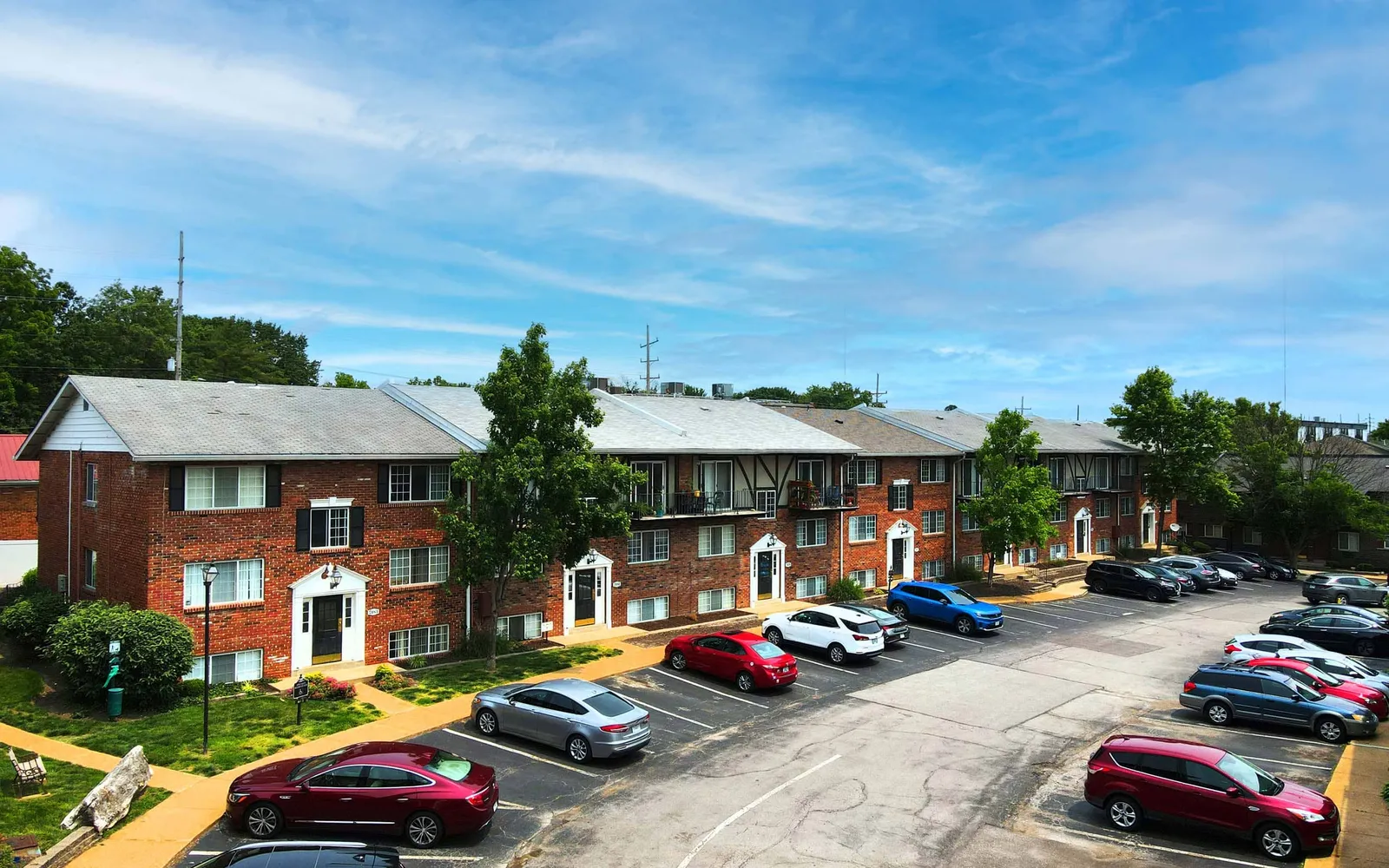 Grant 79 Apartment Homes - a parking lot next to red brick buildings