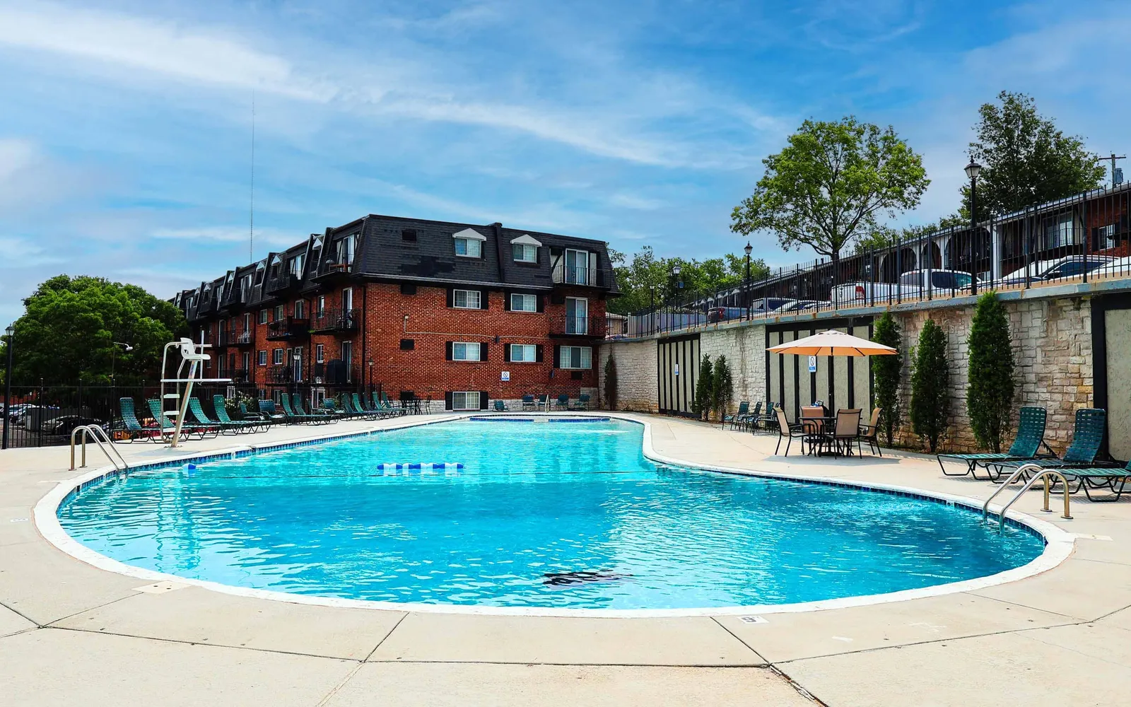 Grant 79 Apartment Homes - a swimming pool with an apartment building next to it