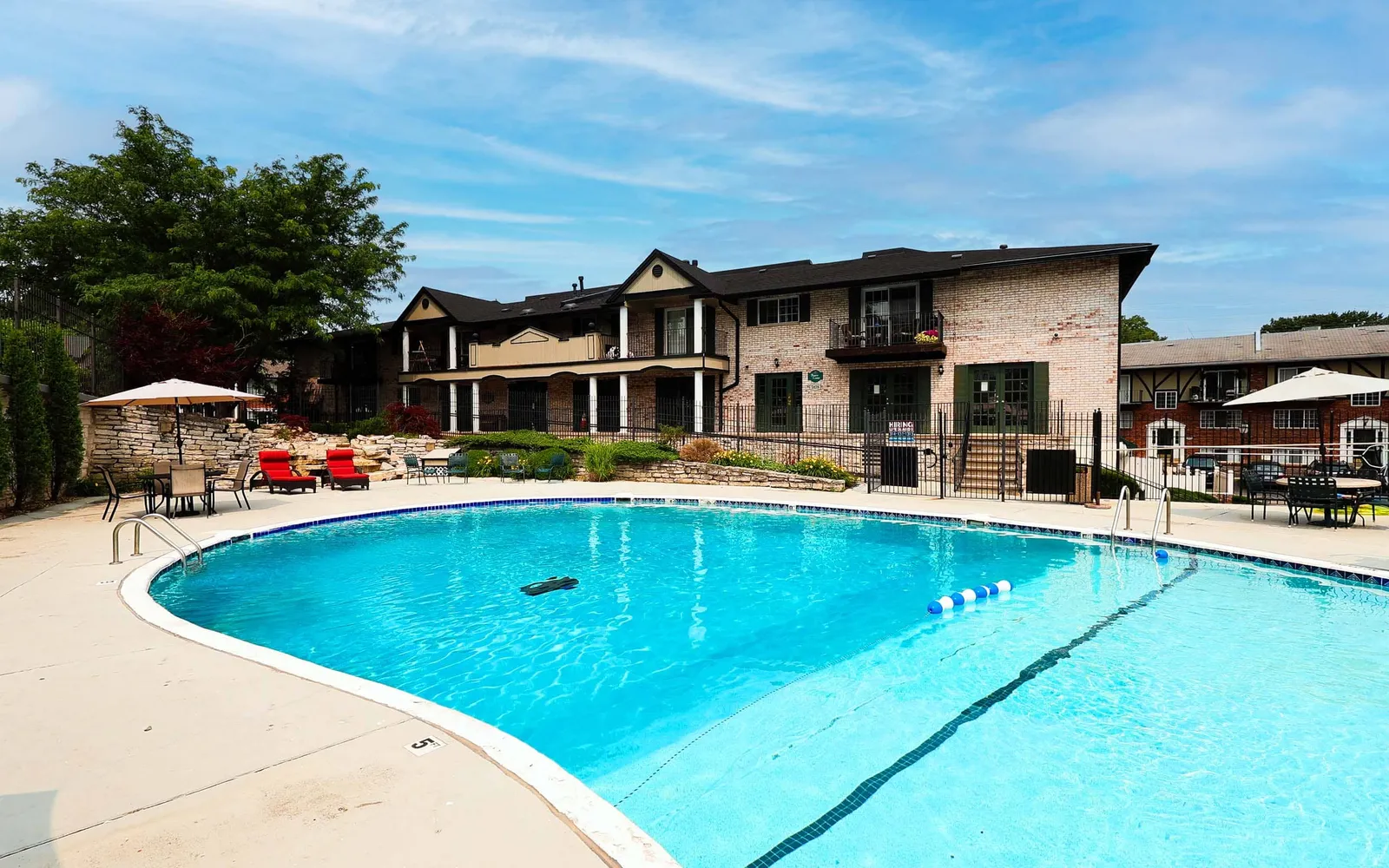 Grant 79 Apartment Homes - a swimming pool with chairs next to it