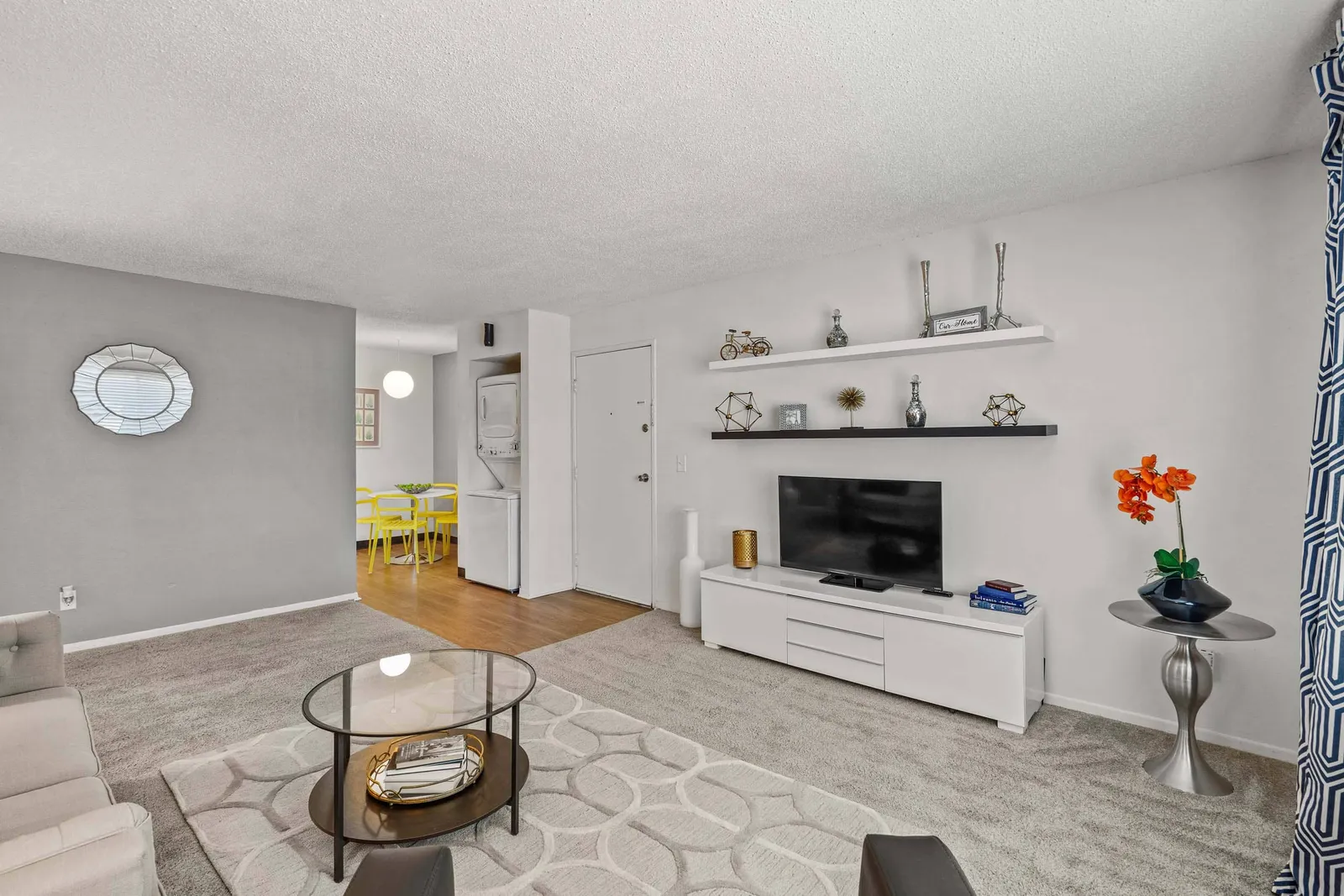 Nori Apartments - a living room with a tv and furniture