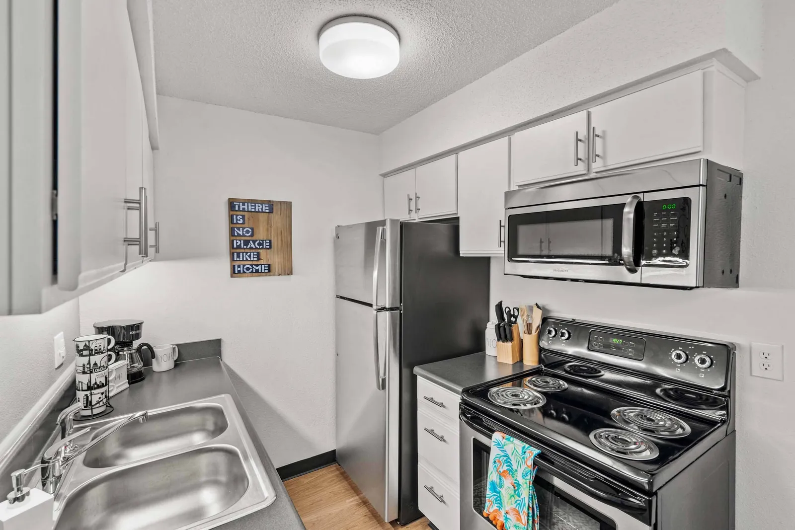 Nori Apartments - a kitchen with light cabinets