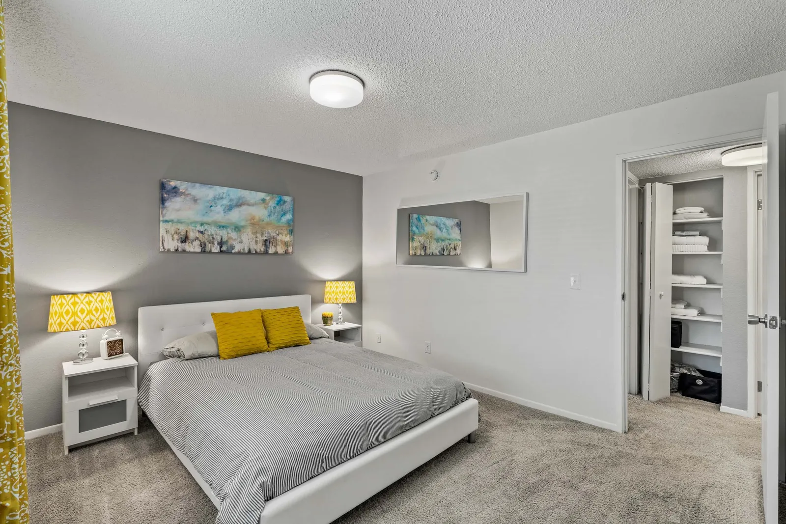 Nori Apartments - a bedroom with a bed and yellow pillows