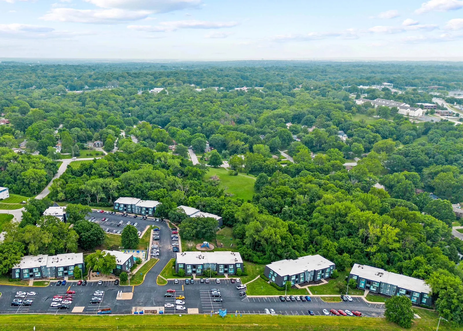 Nori Apartments - an aerial view of the city with lots of trees