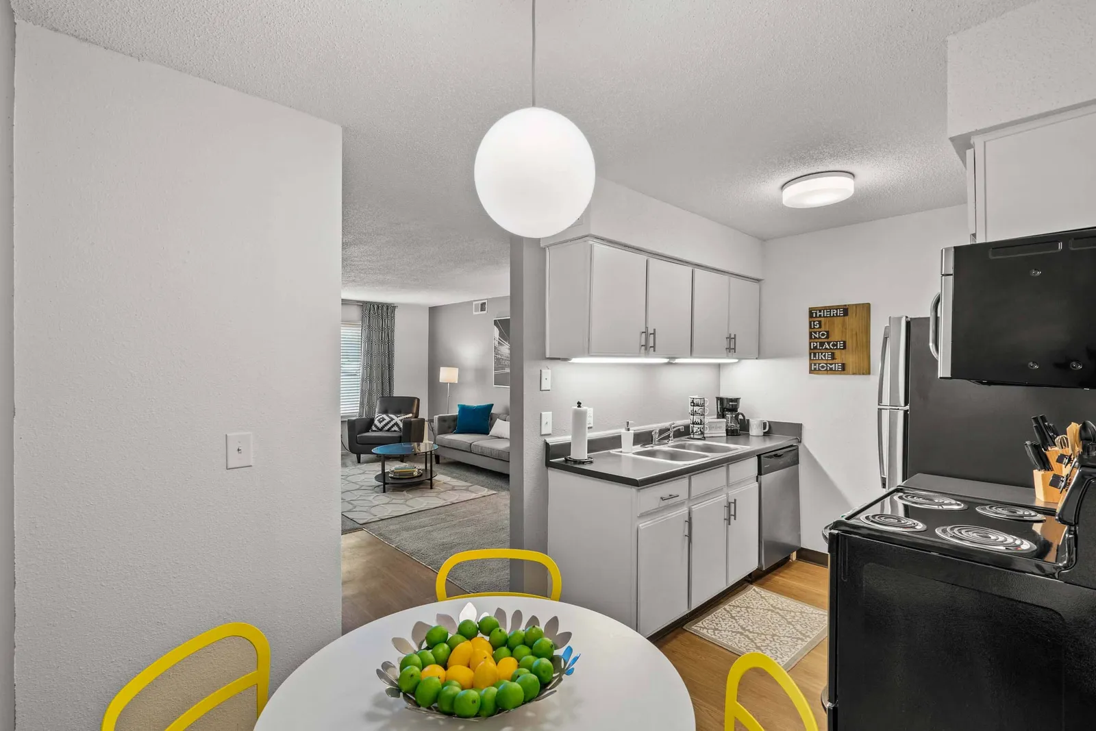 Nori Apartments - a kitchen with a dining room table and hanging light
