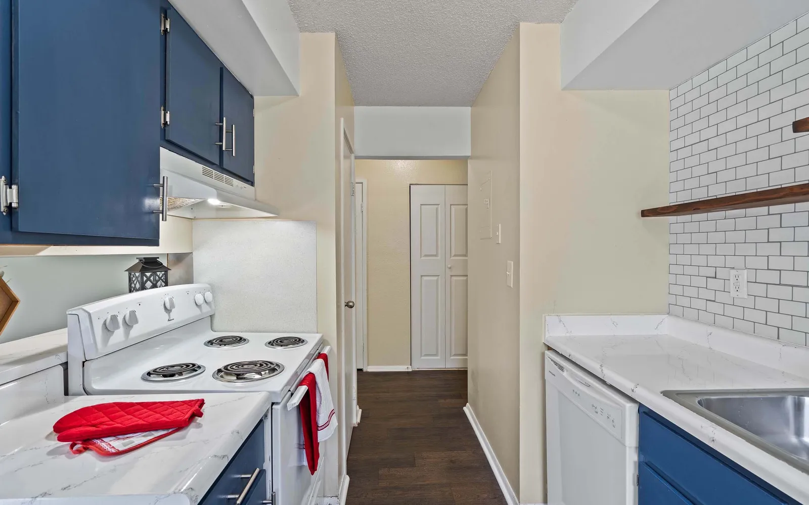 Prairie Walk Apartment Homes - a kitchen with a hallway