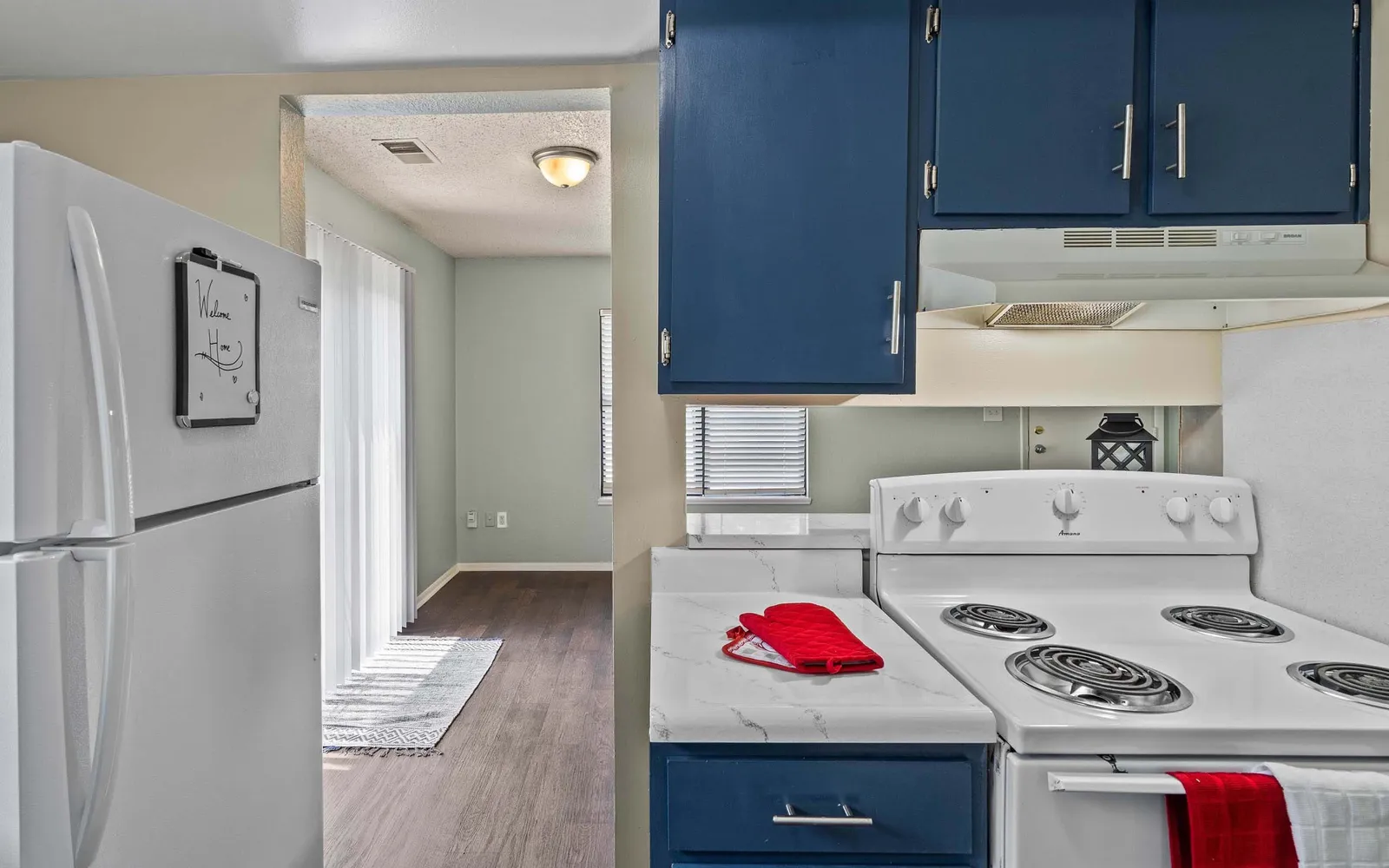 Prairie Walk Apartment Homes - a kitchen with blue cabinets