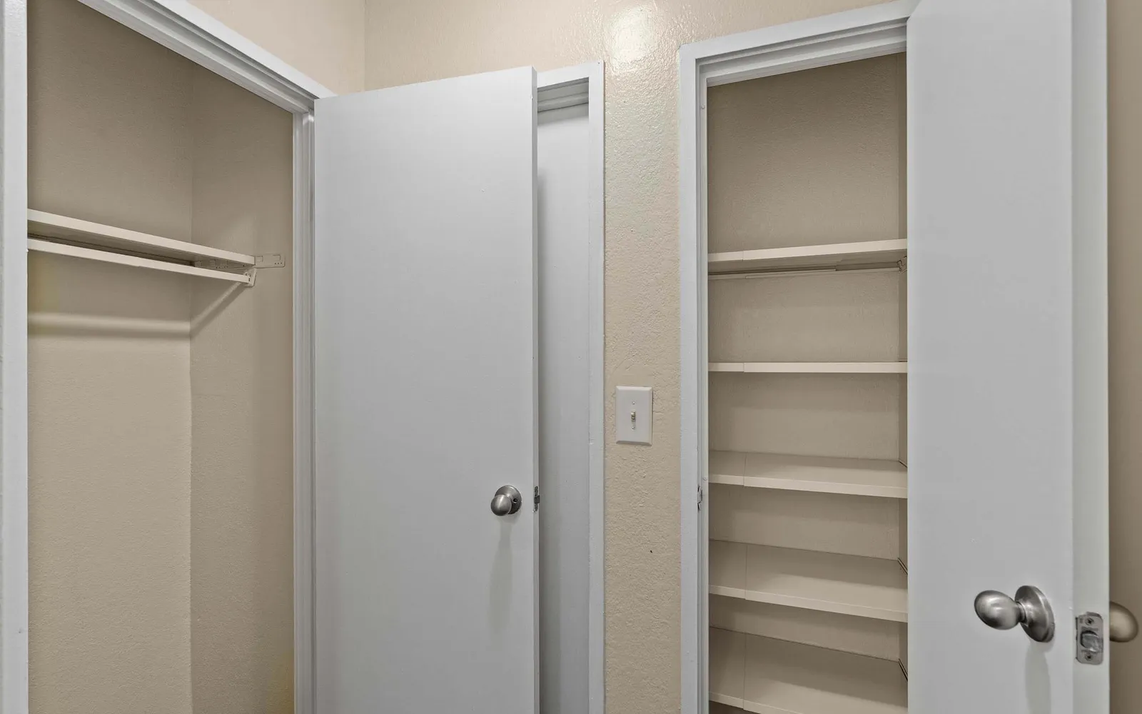 Prairie Walk Apartment Homes - a hallway with two closets