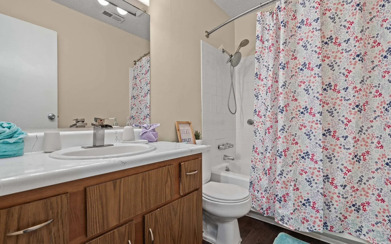 Prairie Walk Apartment Homes - a bathroom with a sink, toilet, and shower tub