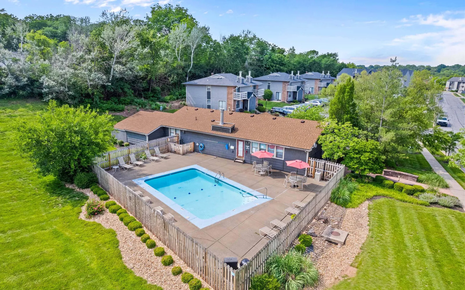 Prairie Walk Apartment Homes - a swimming pool surrounded by chairs and tables