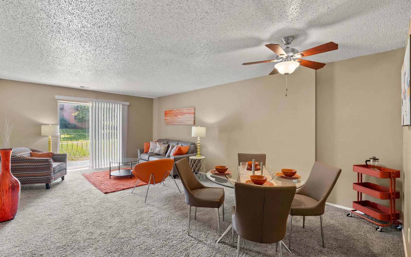 Ridge at Chestnut Apartments - a living room with furniture and sliding door windows