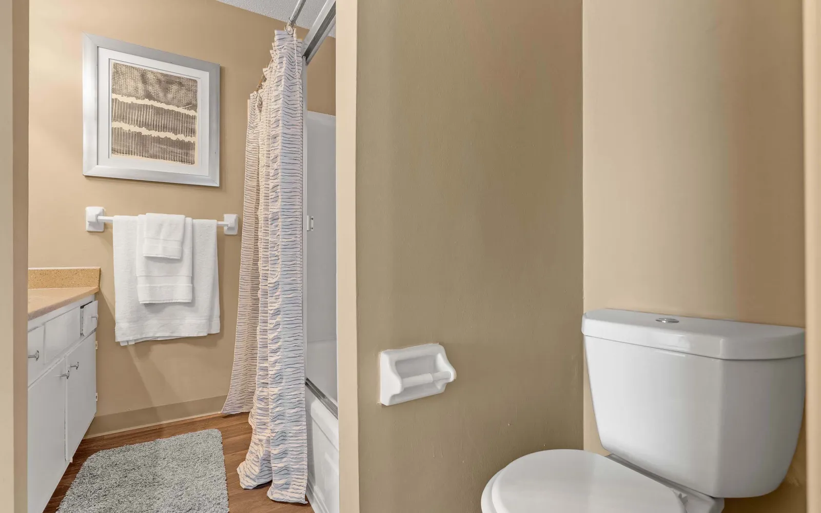 Ridge at Chestnut Apartments - a bathroom with a toilet and shower