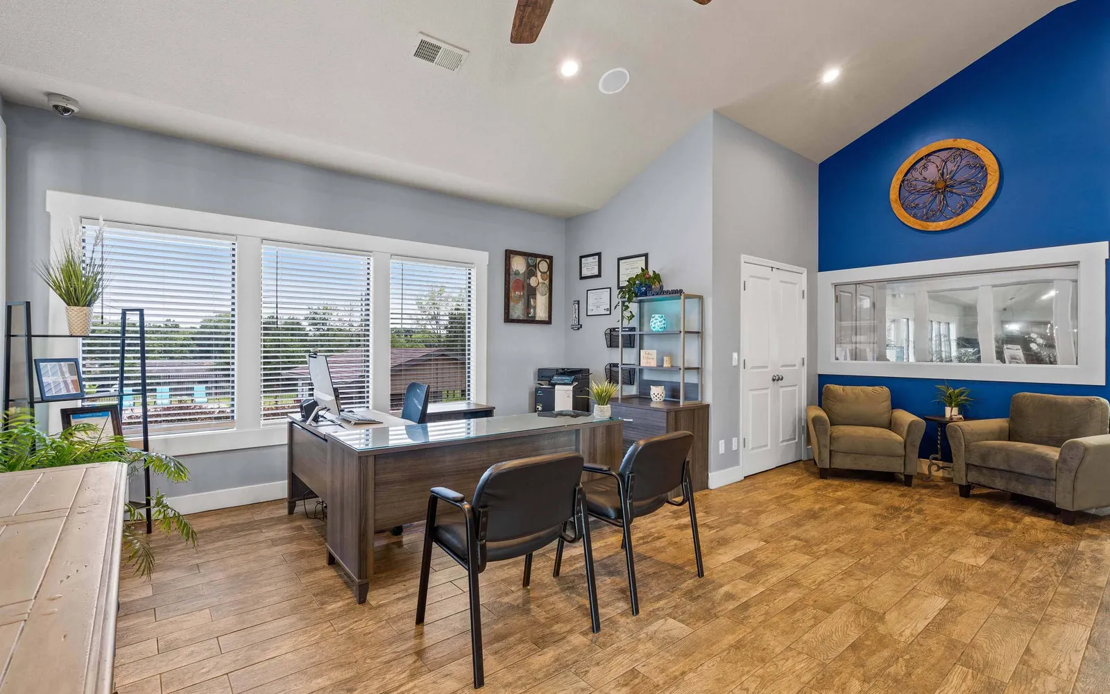 The Hills Apartments - a leasing office with desks and chairs