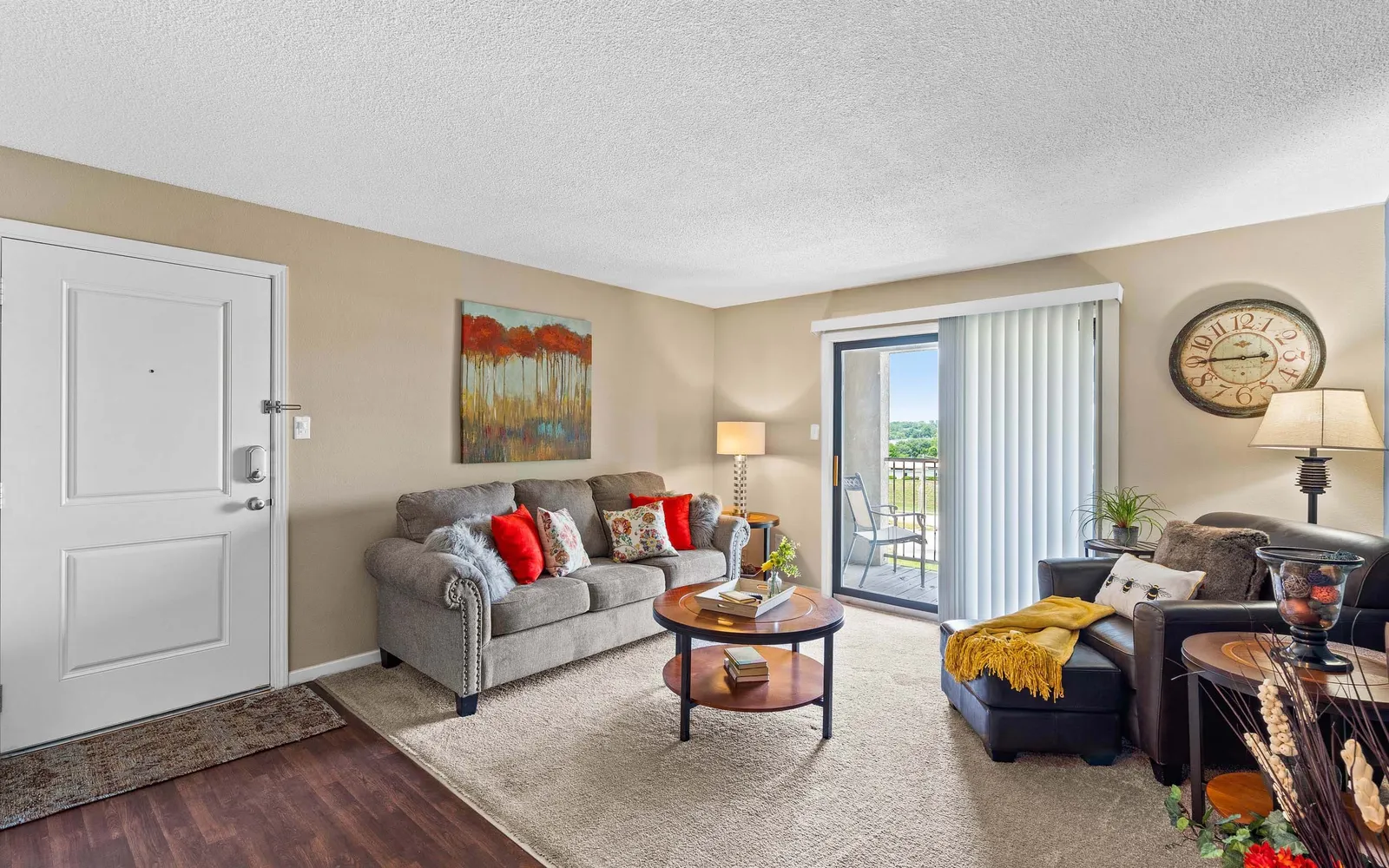 The Hills Apartments - a living room with furniture and sliding door windows