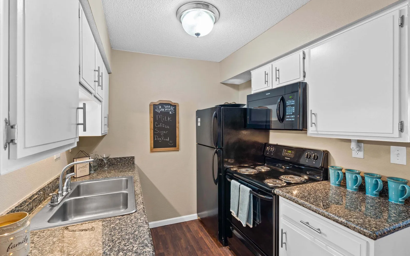 The Hills Apartments - a kitchen with black appliances