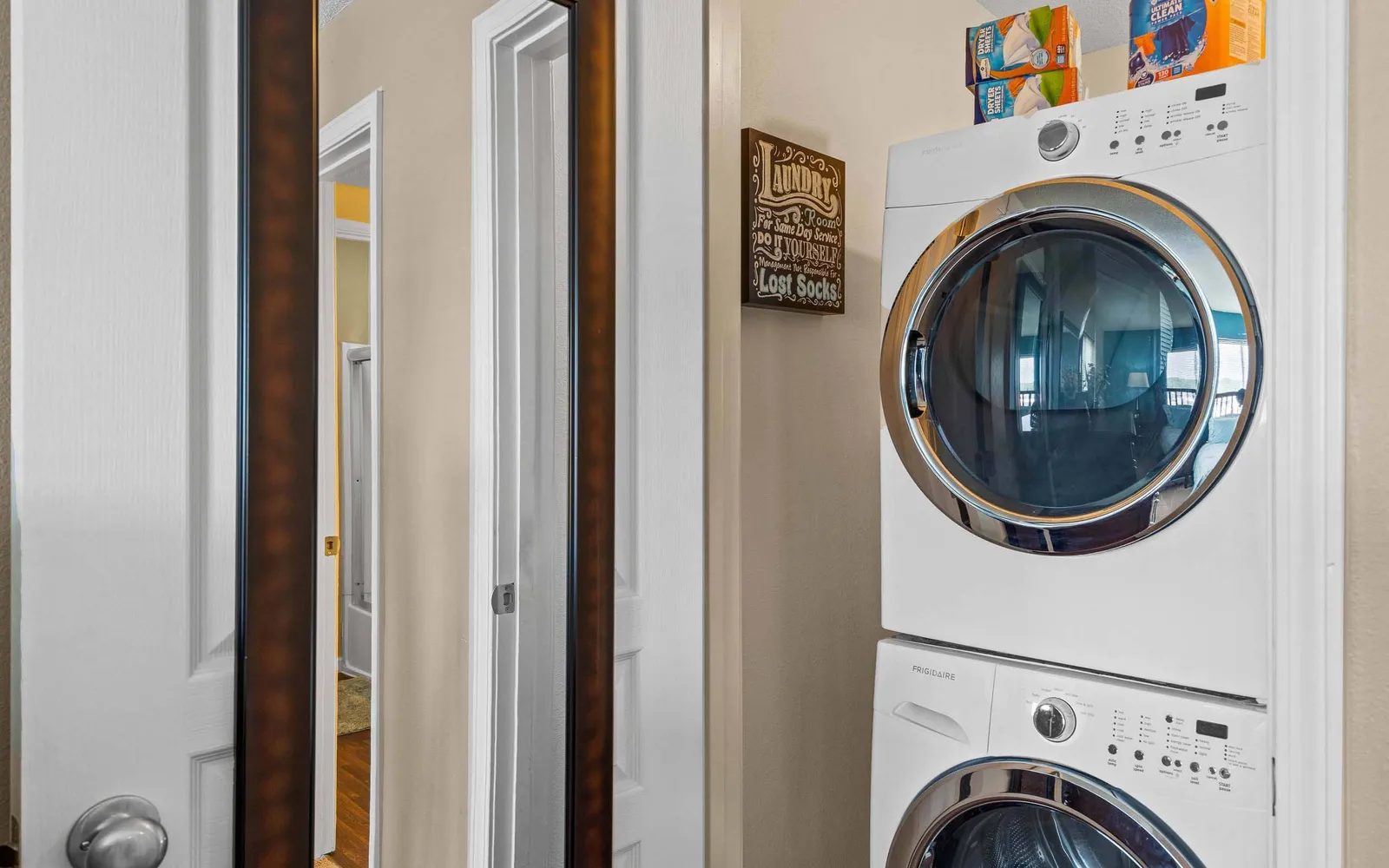 The Hills Apartments - a hallway with a stacked washer and dryer
