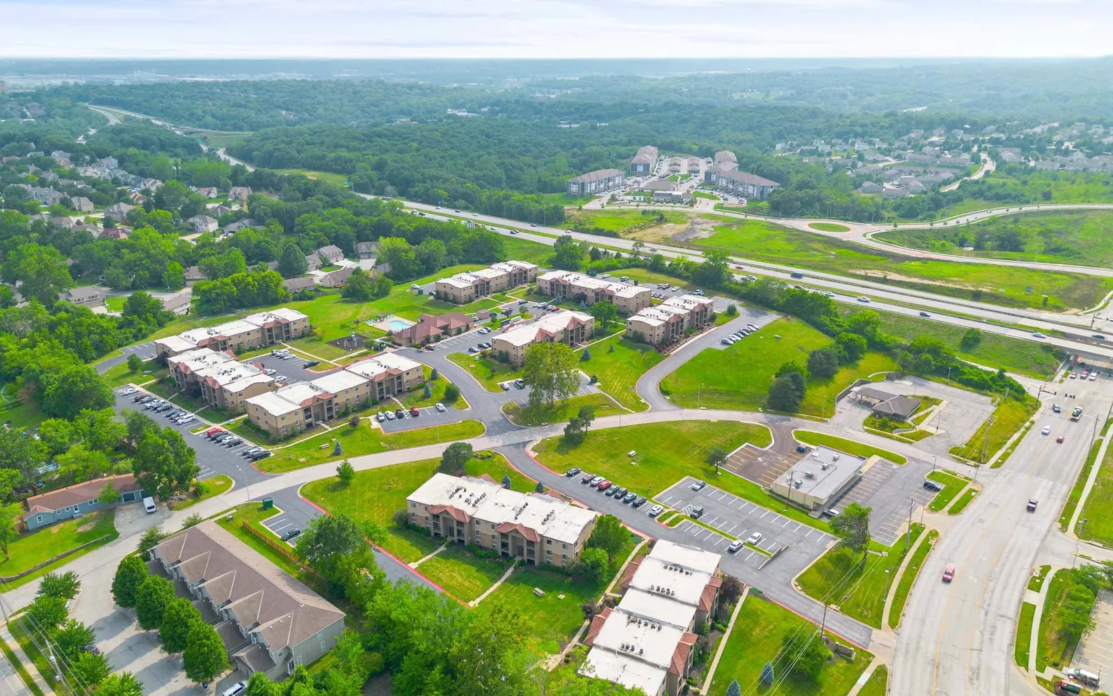 The Hills Apartments - aerial view of apartment buildings and trees