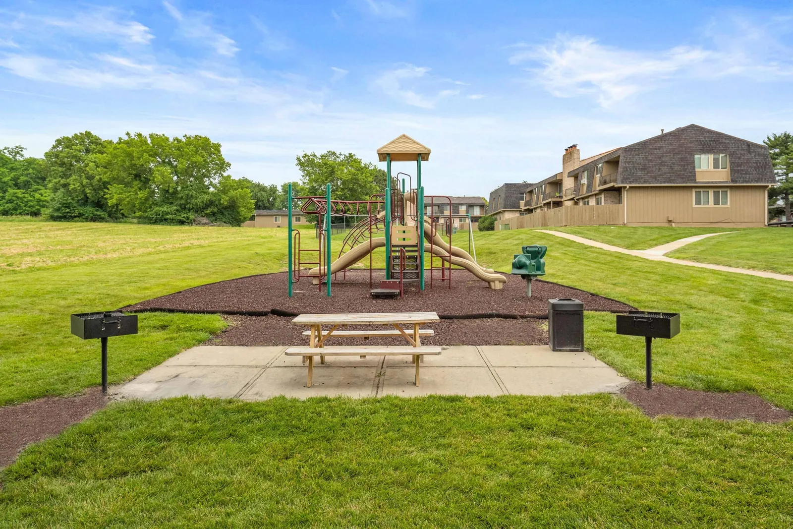 The Oaks at Prairie View - a playground and picnic area surrounded by grass
