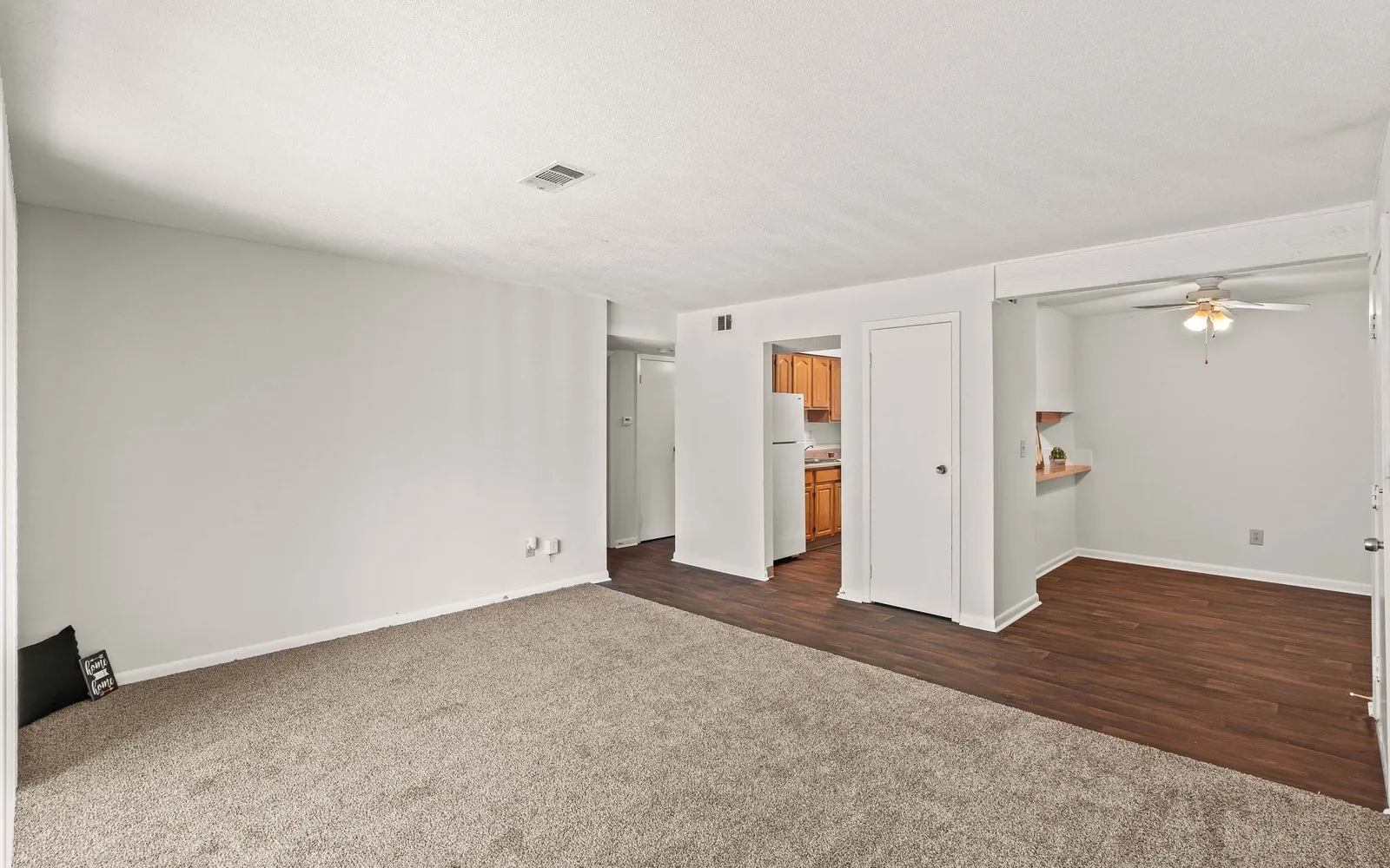 The Retreat at Mill Creek - a living room showcasing a hallway and dining nook