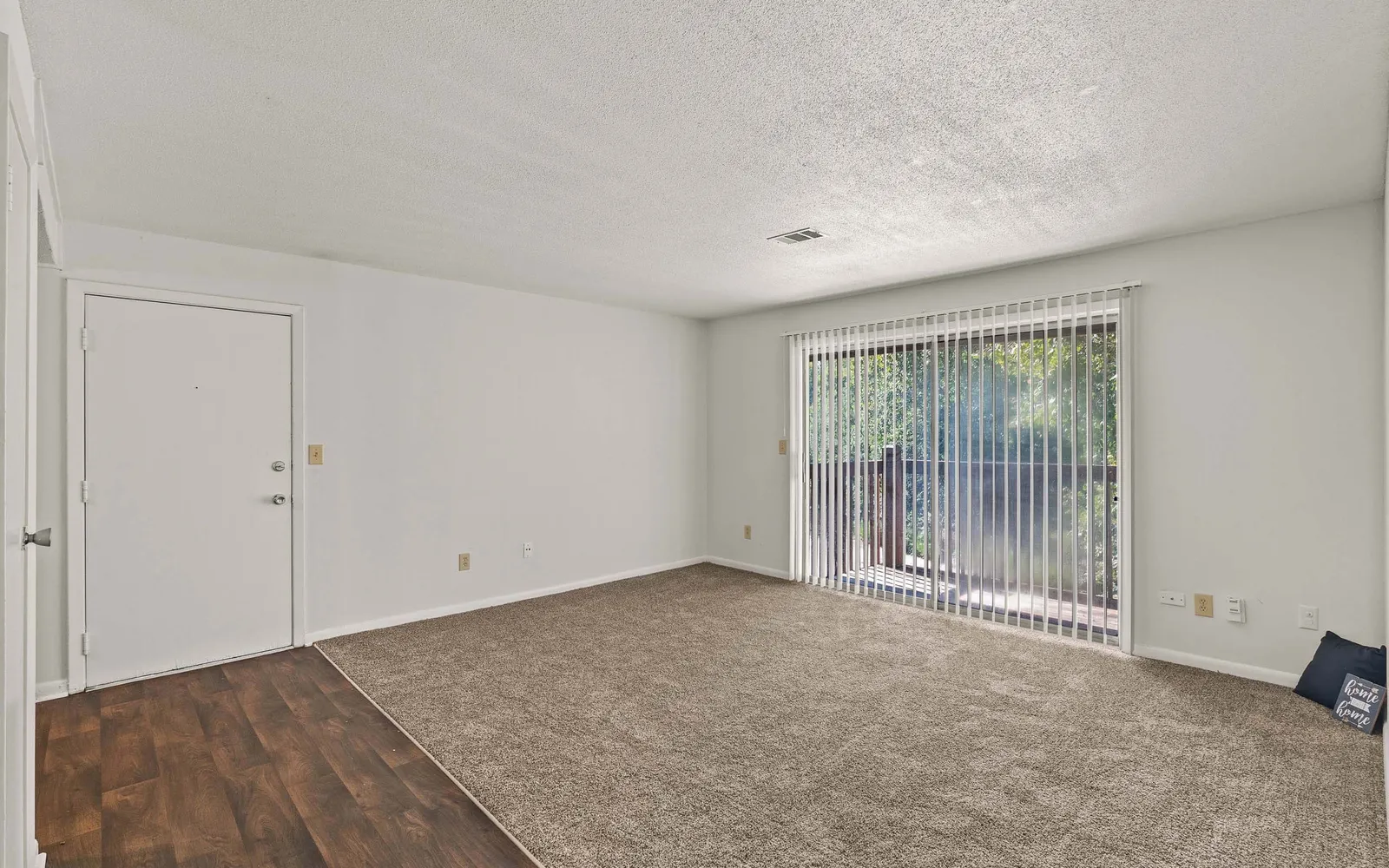 The Retreat at Mill Creek - a living room with sliding door windows