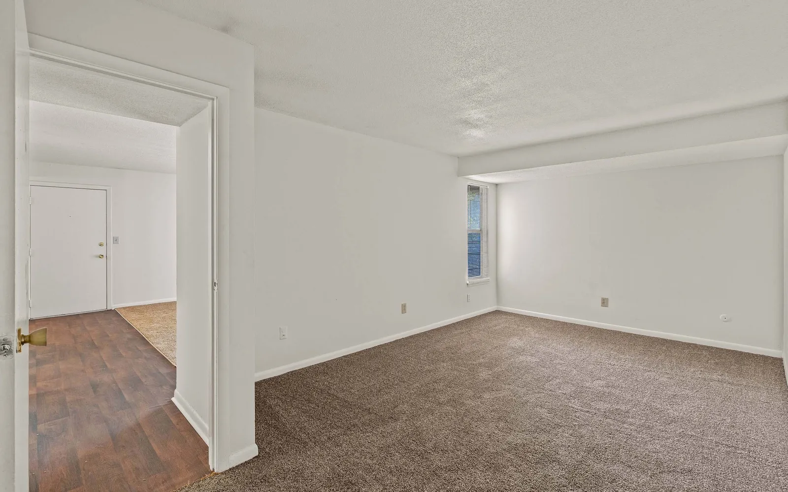 The Retreat at Mill Creek - a bedroom with a window and open door