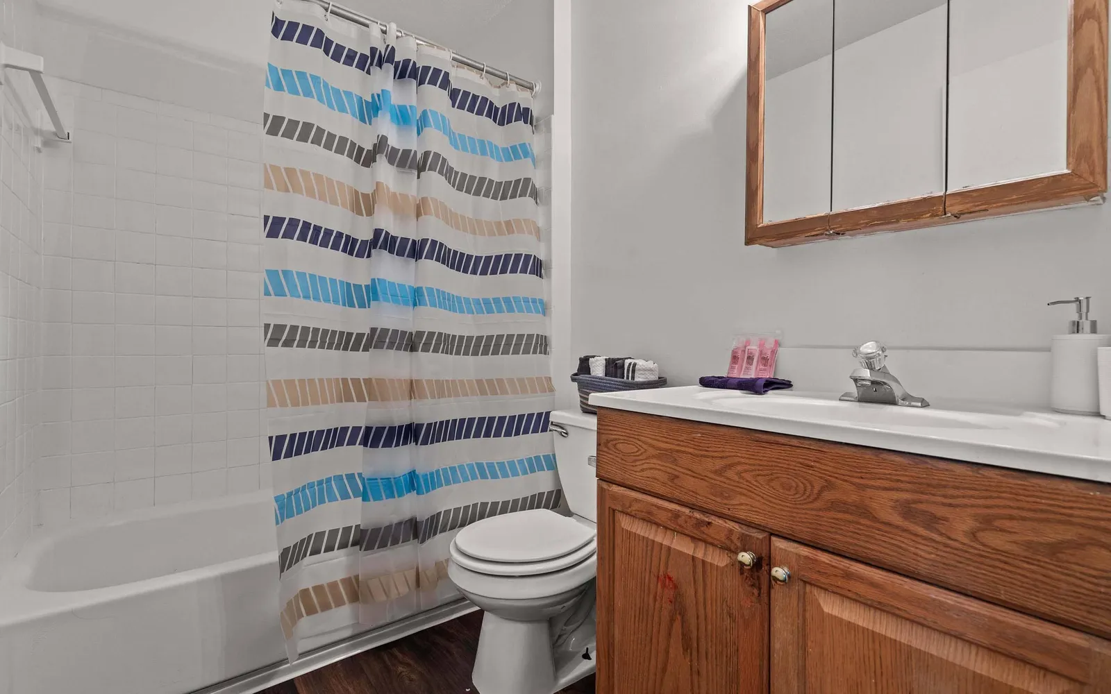 The Retreat at Mill Creek - a bathroom with a sink, toilet, and shower