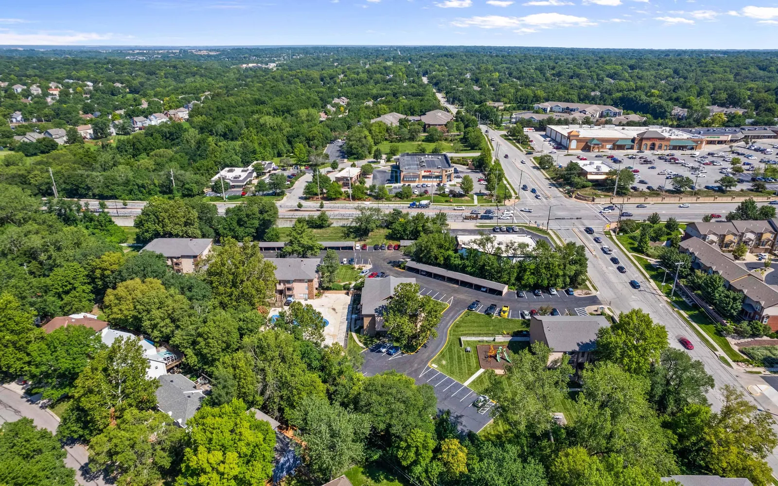 The Retreat at Mill Creek - an aerial view of apartments, roads, and trees
