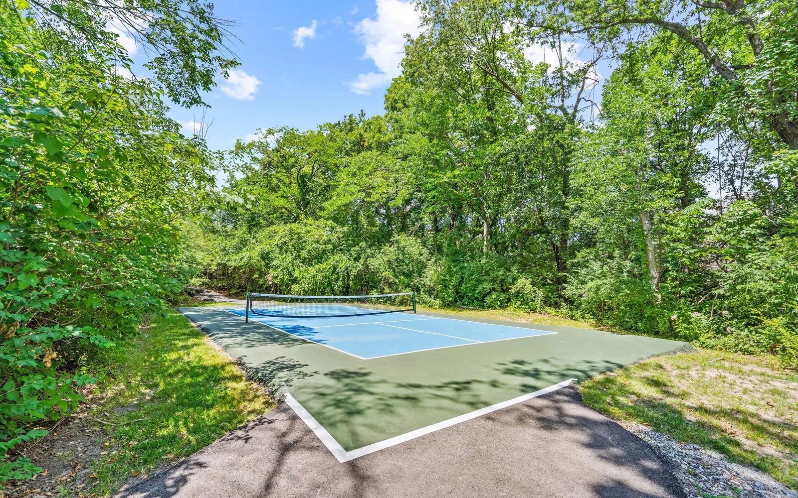 The Retreat at Walnut Creek - a pickle ball court surrounded by trees