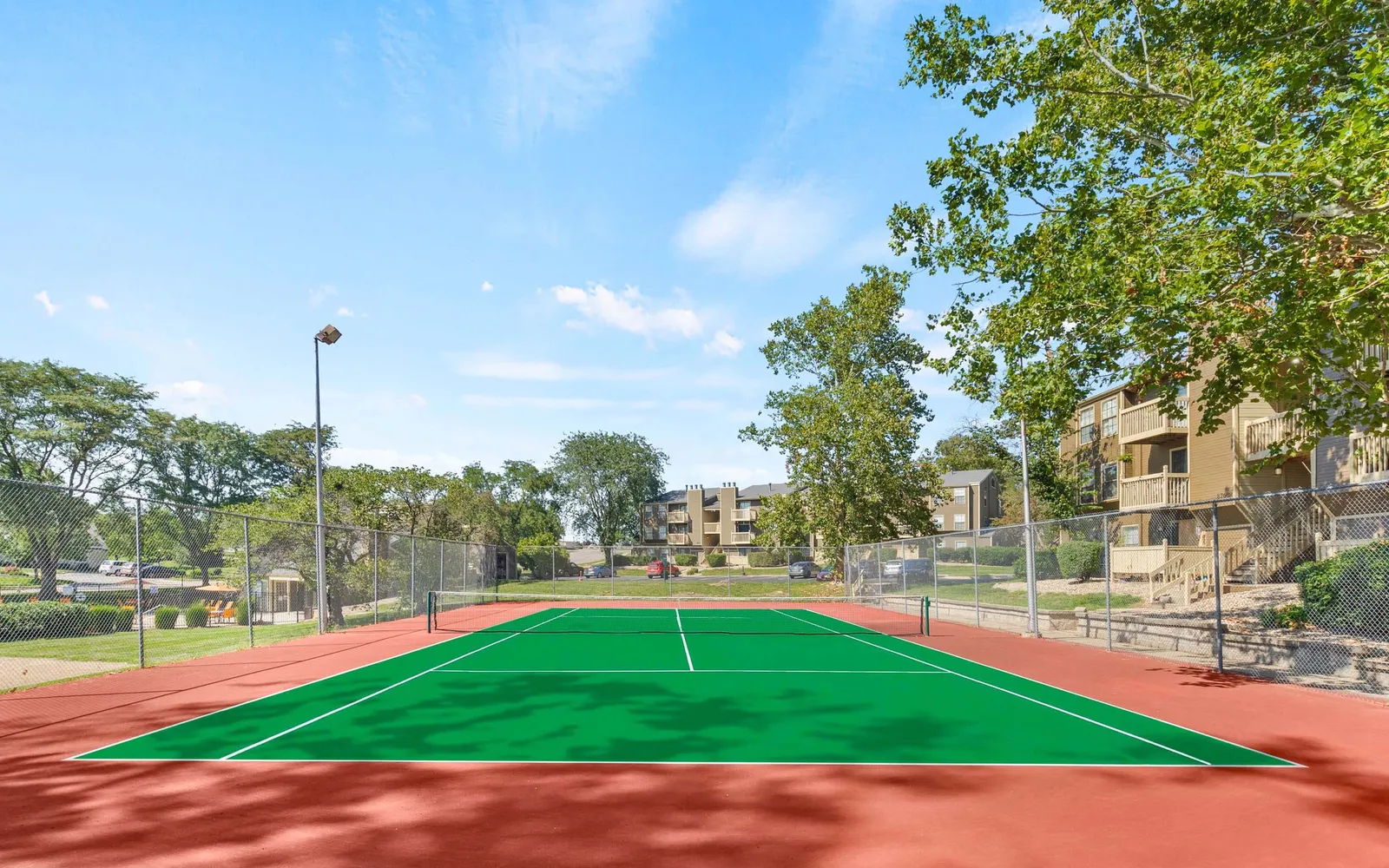The Retreat at Woodridge - a tennis ball court and trees